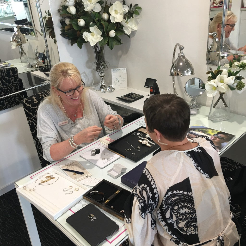 Catherine speaking with a client at the jewellery showroom desk.