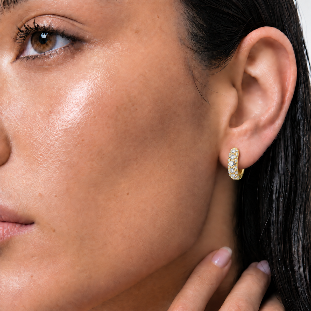 9ct yellow gold diamond huggies worn on the ear