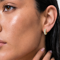 9ct yellow gold diamond huggies worn on the ear