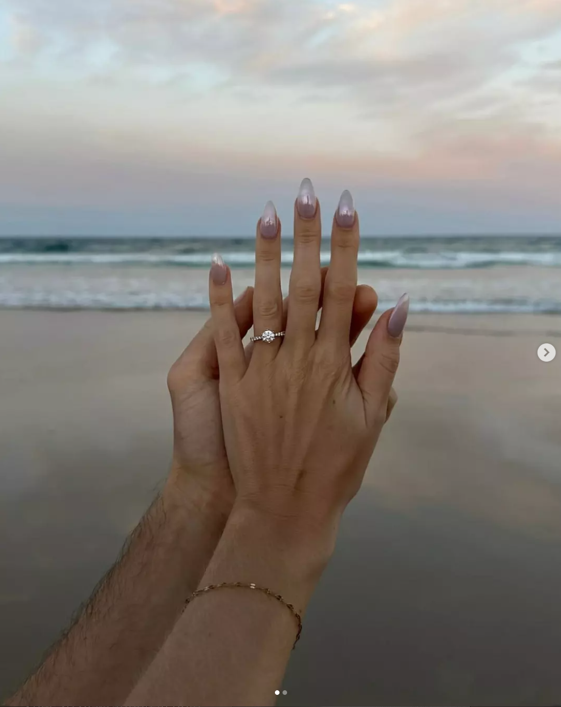 Engagement ring on hand at the beach sunset
